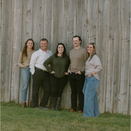 5 people posing in a garden