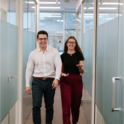 2 professionals walking in the hallway