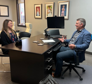 A man and woman talking at the office room