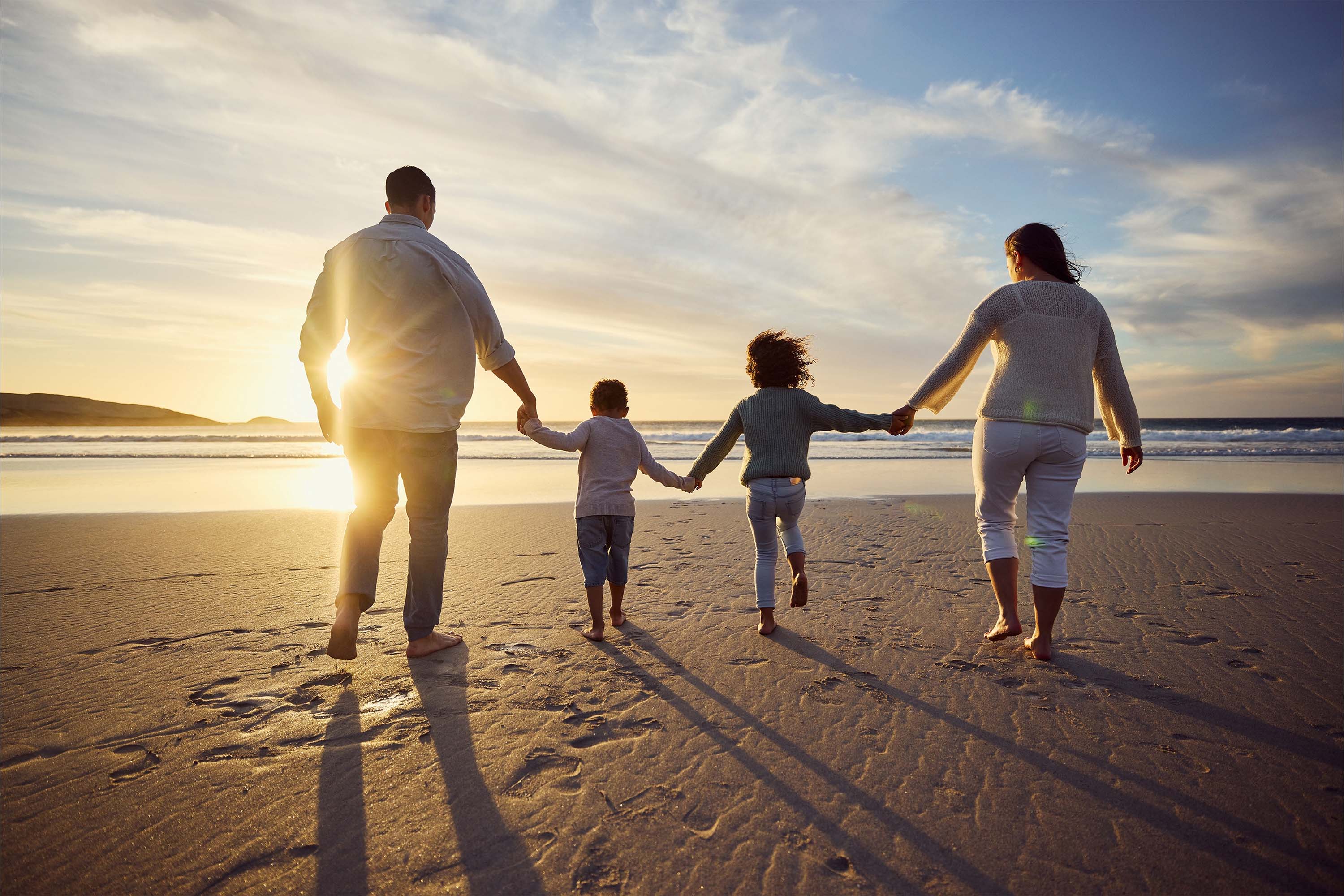 family playing at the beach 