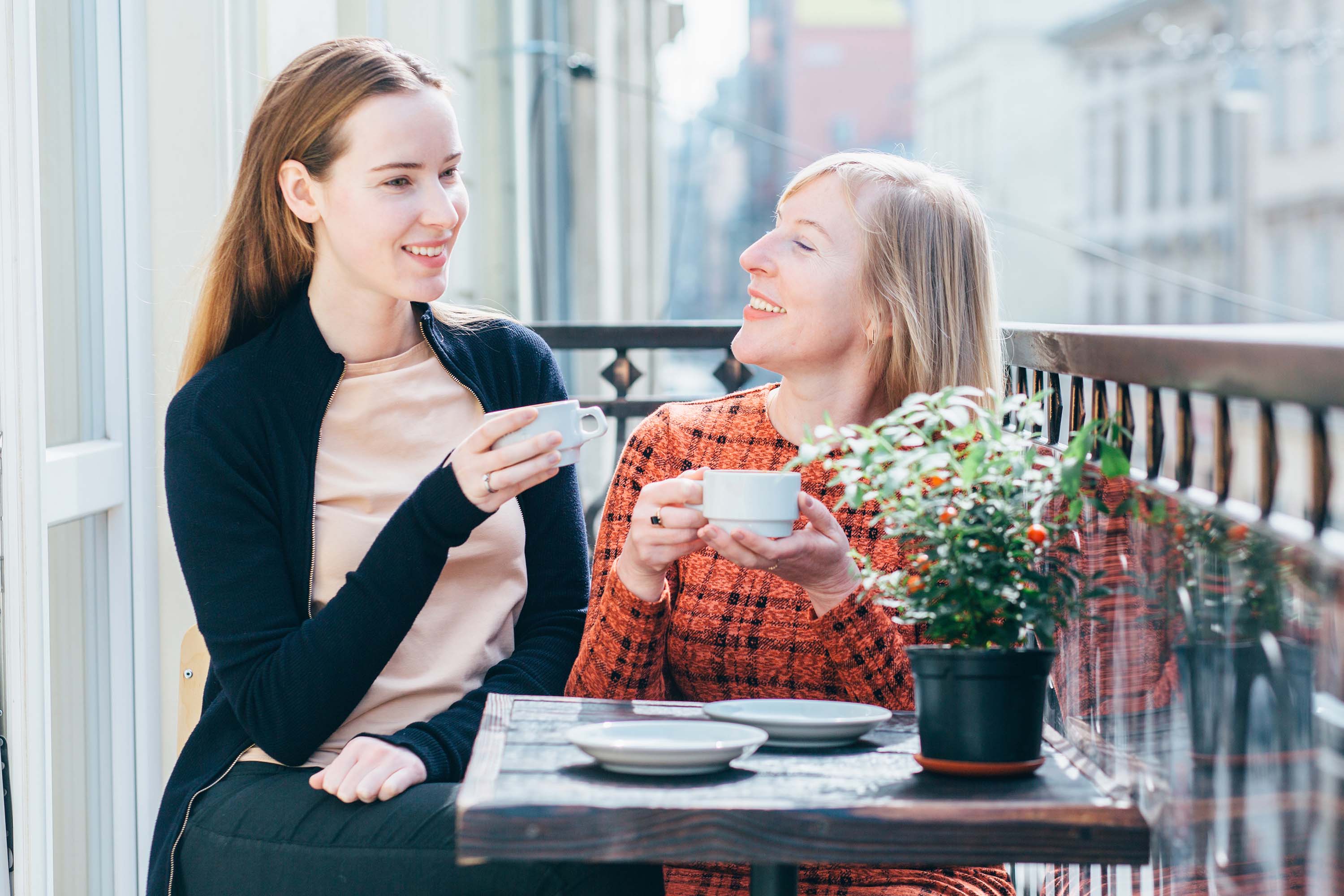 Two woman having coffee in the balcony