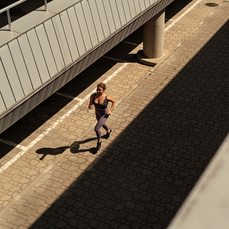 A woman jogging on a street.